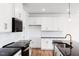 This contemporary kitchen features white cabinets with gold hardware and a black countertop island at 18 Twin Birch Dr, Angier, NC 27501