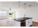 Modern kitchen featuring white cabinets, island with bar seating and wood flooring at 18 Twin Birch Dr, Angier, NC 27501