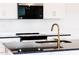 Stylish kitchen with black countertops, white cabinets, and gold hardware at 18 Twin Birch Dr, Angier, NC 27501