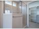 Bathroom with tiled shower and glass door, adjacent to walk in closet at 1805 Bright Lantern Way, Wendell, NC 27591
