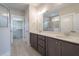 Bathroom featuring double sink vanity, large mirror, walk-in closet and shower at 1805 Bright Lantern Way, Wendell, NC 27591