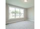 Bright bedroom with neutral carpeting, large window, and natural light at 1805 Bright Lantern Way, Wendell, NC 27591
