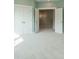 Bedroom with closet doors open to reveal a hallway and stairway at 1805 Bright Lantern Way, Wendell, NC 27591