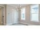 Dining room features a modern chandelier, large windows, light walls and a white door at 1805 Bright Lantern Way, Wendell, NC 27591