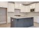 Bright kitchen features a large center island, white cabinets and stainless steel appliances at 1805 Bright Lantern Way, Wendell, NC 27591