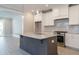 Modern kitchen with granite island, stainless steel appliances, white cabinets, and recessed lighting at 1805 Bright Lantern Way, Wendell, NC 27591