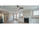 Open-concept living room with fireplace, built-ins, ceiling fan, connects to kitchen and dining area at 1805 Bright Lantern Way, Wendell, NC 27591
