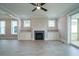 Spacious living room features fireplace, built-in cabinets, ceiling fan, and sliding doors to deck at 1805 Bright Lantern Way, Wendell, NC 27591