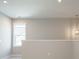 Living room featuring neutral wall color, window for natural light, and hanging light fixture at 1805 Bright Lantern Way, Wendell, NC 27591