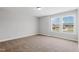 Bright carpeted bedroom with a double window bringing in lots of natural light at 1917 Fishamble St, Fuquay Varina, NC 27526