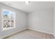 Cozy bedroom with neutral carpeting and a window view of the neighborhood at 1917 Fishamble St, Fuquay Varina, NC 27526