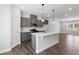 Bright, open kitchen featuring stainless steel appliances, center island, and gray cabinets, perfect for entertaining at 1917 Fishamble St, Fuquay Varina, NC 27526