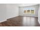 Bright living room featuring wood floors and large windows for natural light at 1917 Fishamble St, Fuquay Varina, NC 27526