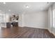 Open-concept living room with a modern kitchen featuring stainless appliances and island seating at 1917 Fishamble St, Fuquay Varina, NC 27526