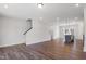 Spacious living area with hardwood floors, a kitchen island, and a staircase at 1917 Fishamble St, Fuquay Varina, NC 27526