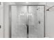 Sleek bathroom shower with frameless glass doors and marble-look tile at 1917 Fishamble St, Fuquay Varina, NC 27526