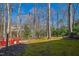 Secluded backyard area with string lights and red Adirondack chairs at 201 Adams Way, Chapel Hill, NC 27516