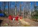 Backyard fire pit area with seating encircled by trees at 201 Adams Way, Chapel Hill, NC 27516