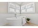 Luxurious bathroom featuring a freestanding tub, complemented by sleek fixtures and natural light at 201 Adams Way, Chapel Hill, NC 27516