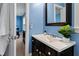 Bathroom with a black vanity, white countertop, and an adjacent blue bedroom at 201 Adams Way, Chapel Hill, NC 27516