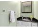 Well-lit powder room with a modern vanity featuring black granite, chrome fixtures, and fresh white towels at 201 Adams Way, Chapel Hill, NC 27516