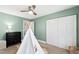 Bedroom with soft green walls, carpeted floors, a white teepee, and white closet doors at 201 Adams Way, Chapel Hill, NC 27516