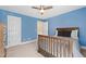 Bedroom with blue walls, a wooden bed frame, ceiling fan, and white trim at 201 Adams Way, Chapel Hill, NC 27516