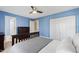 Bedroom with blue walls, a ceiling fan, white trim, carpet flooring, and white bedding at 201 Adams Way, Chapel Hill, NC 27516