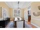 Sunlit dining area with a wooden table, area rug, and access to a kitchen featuring stainless steel appliances at 201 Adams Way, Chapel Hill, NC 27516