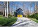 Charming home with a blue exterior, yellow garage door, and a winding driveway at 201 Adams Way, Chapel Hill, NC 27516