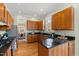 Traditional kitchen with oak cabinets, granite counters, stainless steel appliances, and hardwood flooring at 201 Adams Way, Chapel Hill, NC 27516