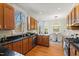 Bright kitchen with granite countertops, oak cabinets, stainless steel appliances, and adjacent dining area at 201 Adams Way, Chapel Hill, NC 27516