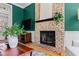 Close-up of a brick fireplace and mantle in a cozy living room with hardwood floors and stylish decor at 201 Adams Way, Chapel Hill, NC 27516