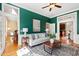 Inviting living room with green walls, hardwood floors, and comfortable seating at 201 Adams Way, Chapel Hill, NC 27516