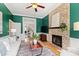 Cozy living room with a brick fireplace, hardwood floors, and comfortable seating at 201 Adams Way, Chapel Hill, NC 27516