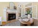Bright living room featuring a fireplace, French doors, and a comfortable seating area at 201 Adams Way, Chapel Hill, NC 27516
