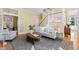 Cozy living room with a staircase, comfortable seating, and hardwood floors for a warm ambiance at 201 Adams Way, Chapel Hill, NC 27516