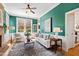Stylish living room with green walls, a brick fireplace, and an inviting seating arrangement at 201 Adams Way, Chapel Hill, NC 27516