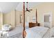 Expansive main bedroom with high ceilings, a four-poster bed, sitting area, and staircase to upper level at 201 Adams Way, Chapel Hill, NC 27516