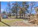 Backyard showing a storage shed and wooded area as seen from the home's back porch at 2080 Saint Paul Church Rd, Roxboro, NC 27574