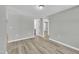 An empty bedroom boasts light gray walls, light wood flooring, and neutral lighting fixtures at 2080 Saint Paul Church Rd, Roxboro, NC 27574
