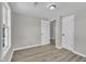 Bedroom featuring neutral walls, wood floors, a window overlooking a yard, and two entry doors at 2080 Saint Paul Church Rd, Roxboro, NC 27574