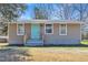 Charming single-story home featuring a vibrant turquoise door and freshly painted exterior at 2080 Saint Paul Church Rd, Roxboro, NC 27574