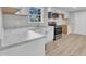Bright kitchen boasts stainless steel appliances, white cabinets, and an eat-in dining area at 2080 Saint Paul Church Rd, Roxboro, NC 27574