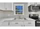 A stainless sink beneath a window enhances this bright and tidy kitchen at 2080 Saint Paul Church Rd, Roxboro, NC 27574