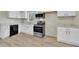 A bright kitchen features stainless appliances, and white cabinets at 2080 Saint Paul Church Rd, Roxboro, NC 27574
