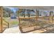 Inviting porch with wood flooring, railings, and a view of the yard and storage shed at 2080 Saint Paul Church Rd, Roxboro, NC 27574