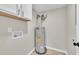 A hot water heater is tucked neatly into a utility space with overhead cabinets at 2080 Saint Paul Church Rd, Roxboro, NC 27574