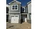 Charming townhome exterior with gray siding, white trim, and a one-car garage at 21 Silver Pine Dr, Angier, NC 27501