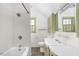 Bright bathroom with tub and shower combination, complemented by a white vanity at 2120 Cokey Rd, Rocky Mount, NC 27801